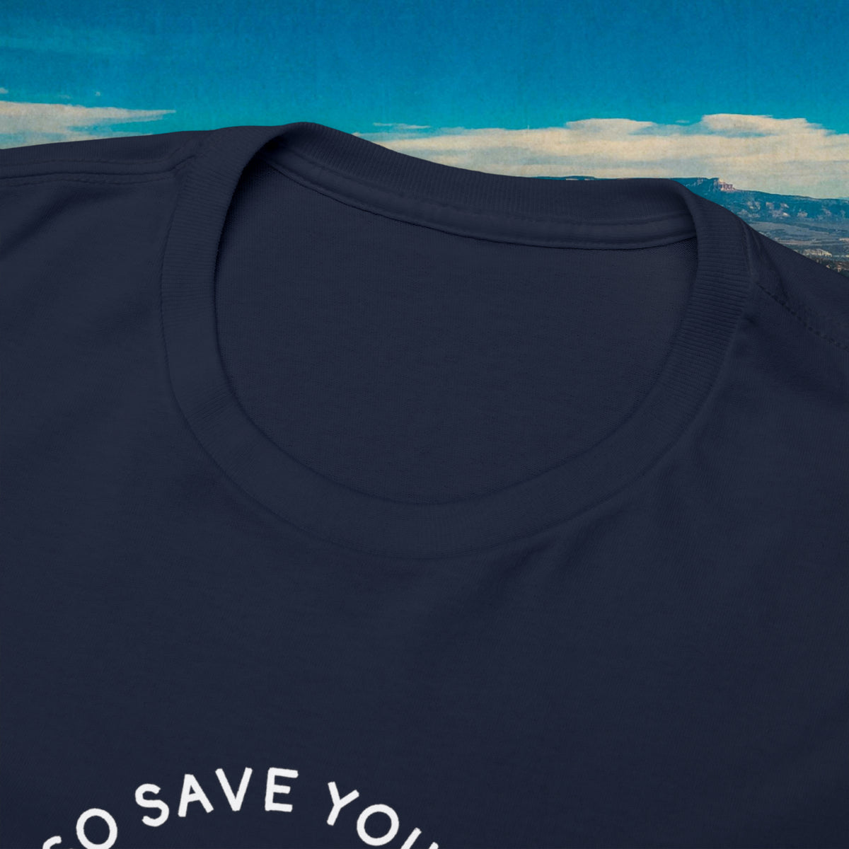Close-up of the navy Save Your Breath shirt neckline and white lettering