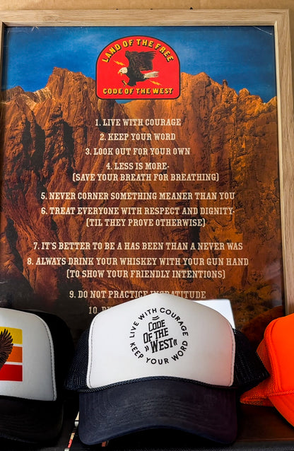 Grandpa’s Cafe hat displayed below a framed Code of the West poster