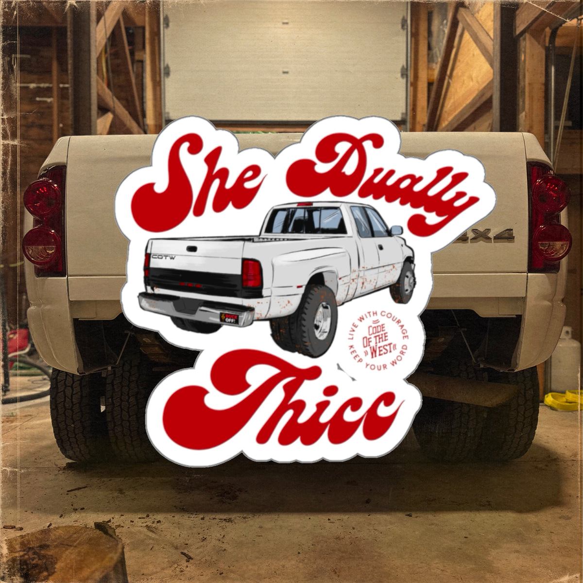 She Dually Thicc decal with a white dually pickup and red script, shown in front of a truck