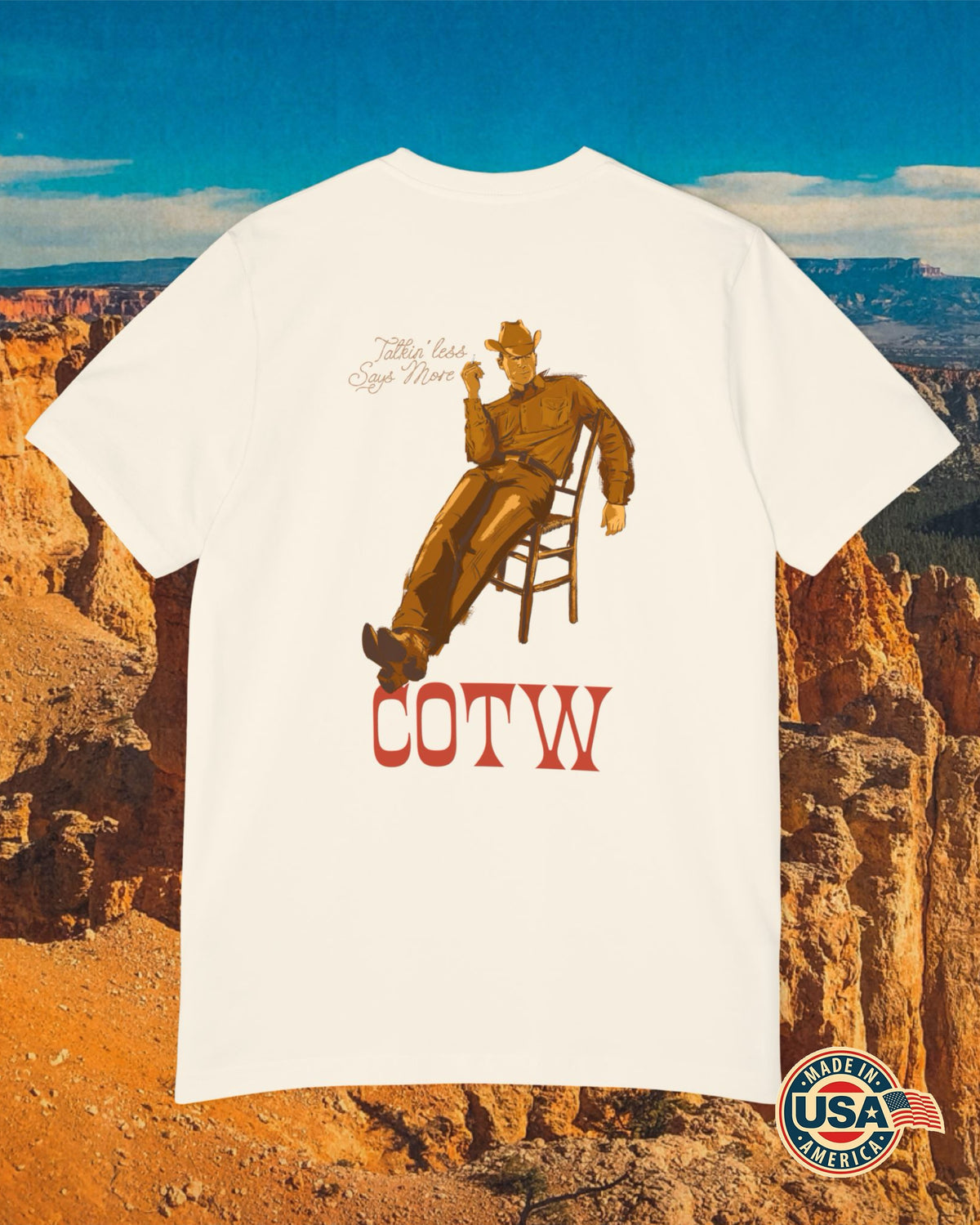 Natural Talkin’ Less Says More T-shirt with a cowboy leaning back in a chair above COTW lettering