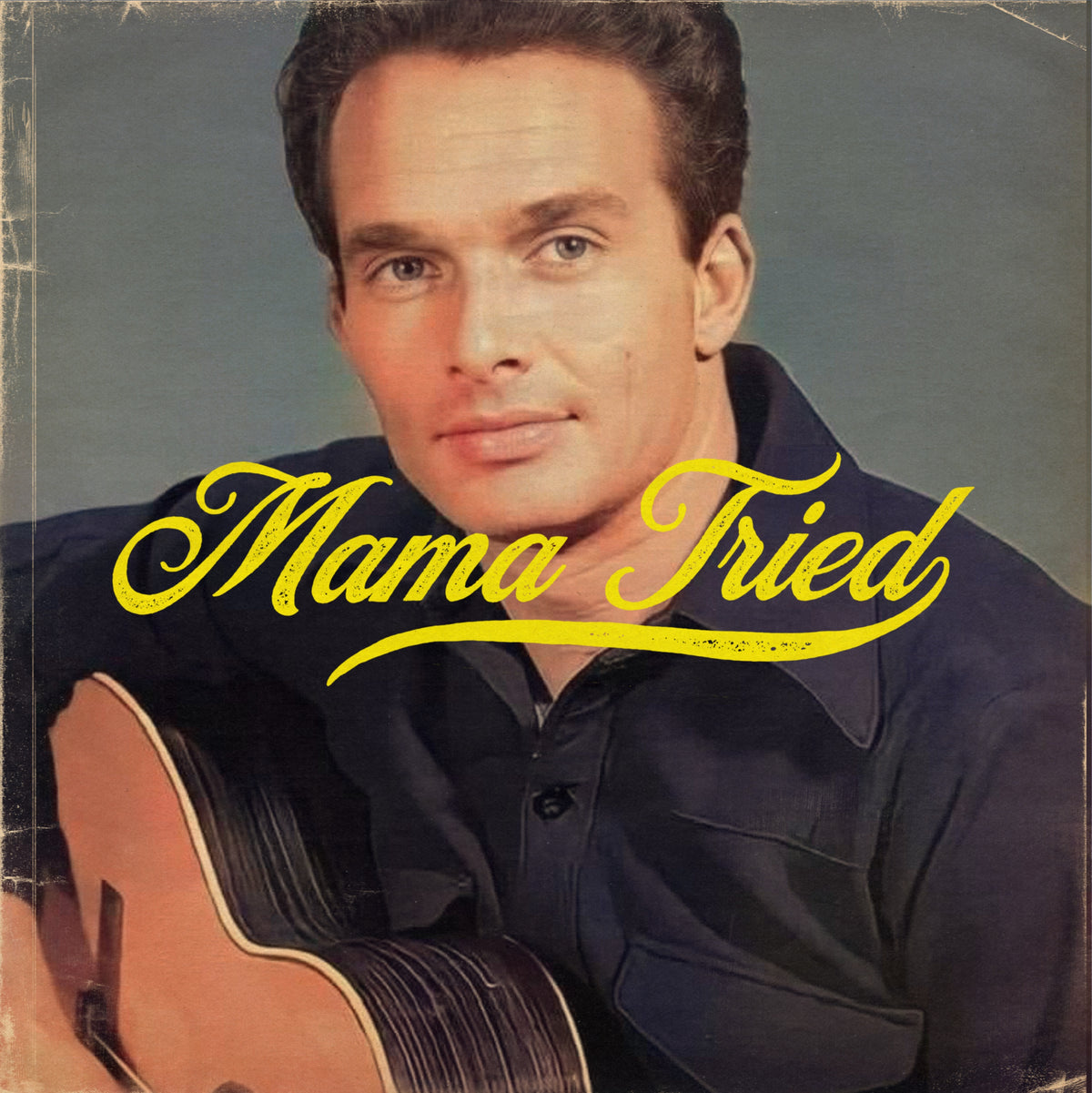 Portrait of a man holding a guitar with yellow Mama Tried lettering