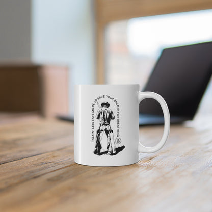 White Save Your Breath mug on a wooden table