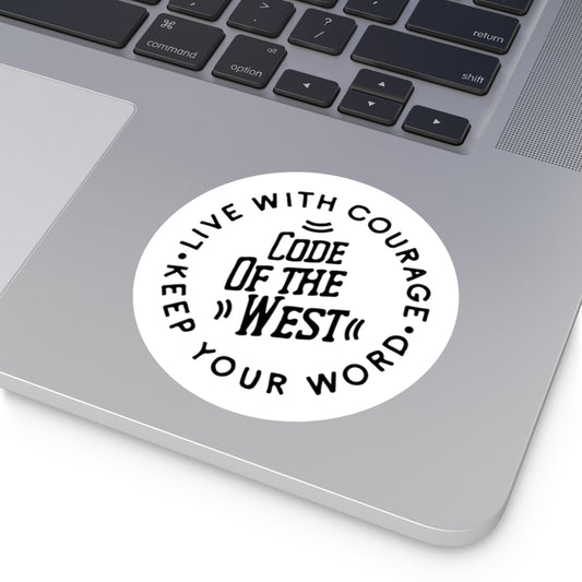 Round Code of the West sticker applied beside a laptop keyboard