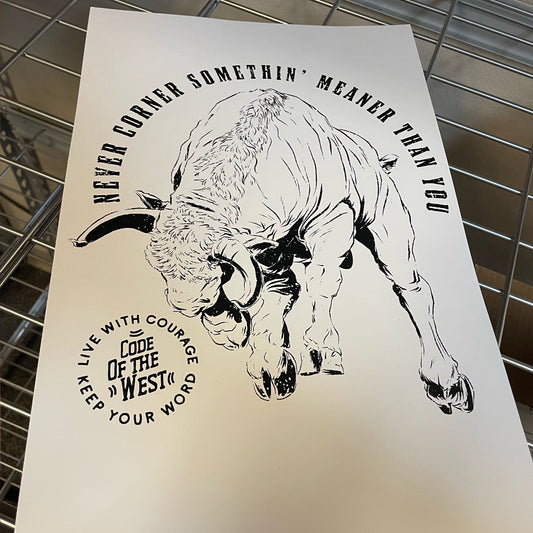 Charging Bull screen print with a black bull drawing and Never Corner Something Meaner Than You lettering