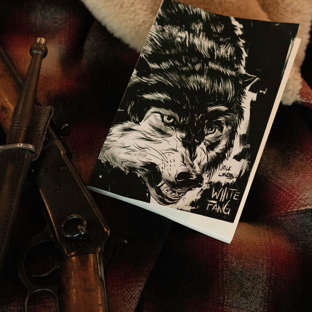 White Fang book with black-and-white wolf cover artwork by Chris Hunt