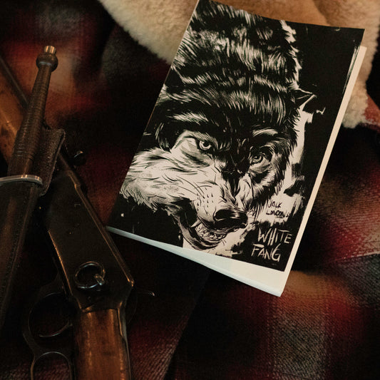 White Fang book with black-and-white wolf cover artwork by Chris Hunt