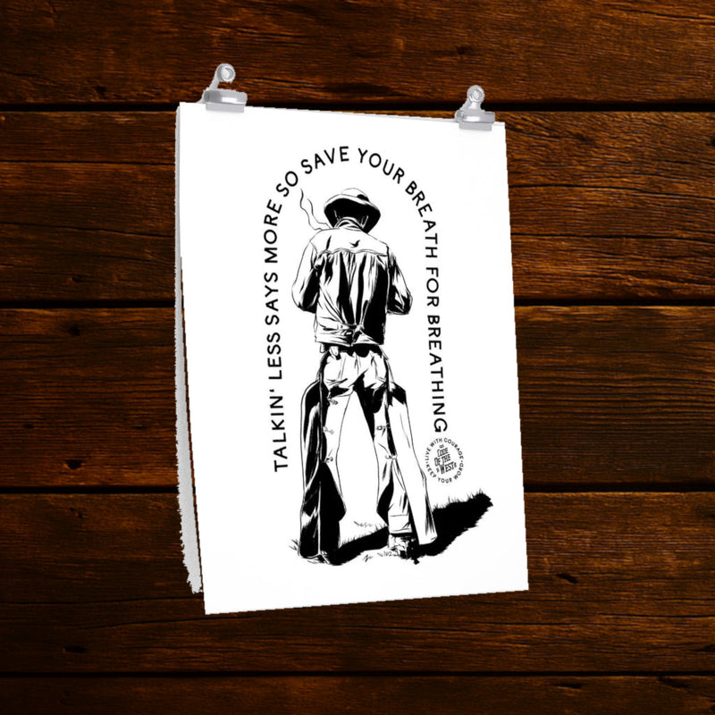 Talkin’ Less Says More art print with a cowboy seated backward on a chair and curved black lettering