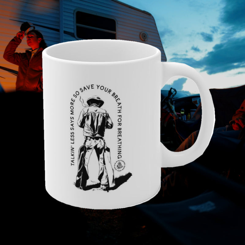 White Save Your Breath mug with a black cowboy drawing and Talkin’ Less Says More lettering