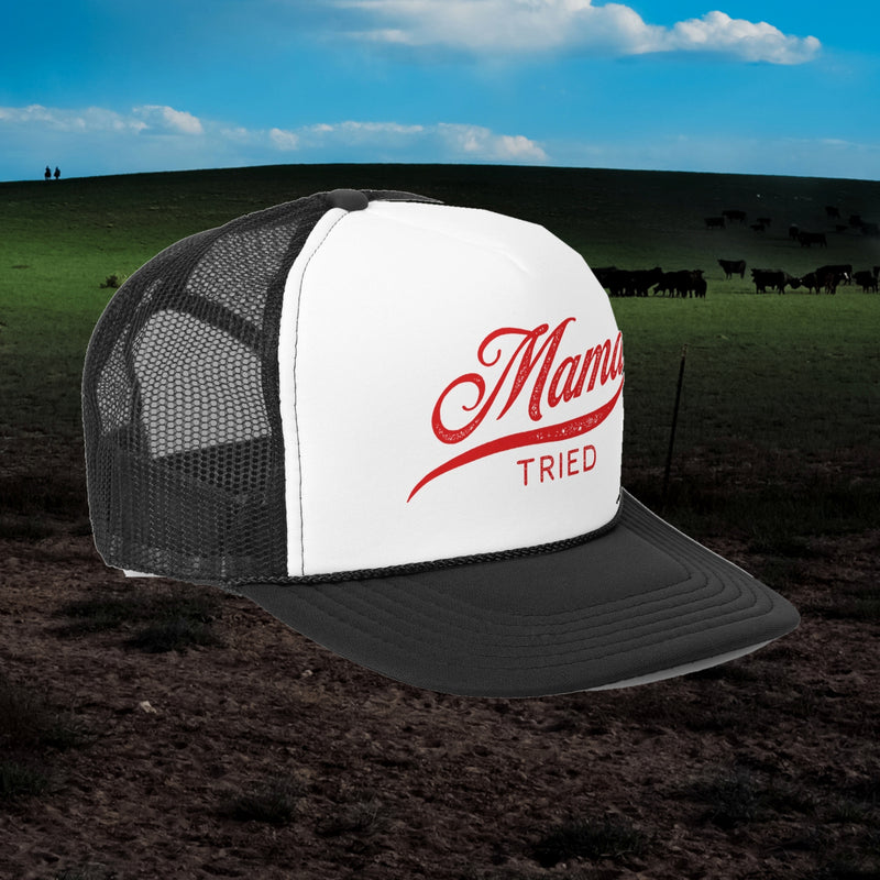 Mama Tried trucker hat in black with white front and red script, angled view