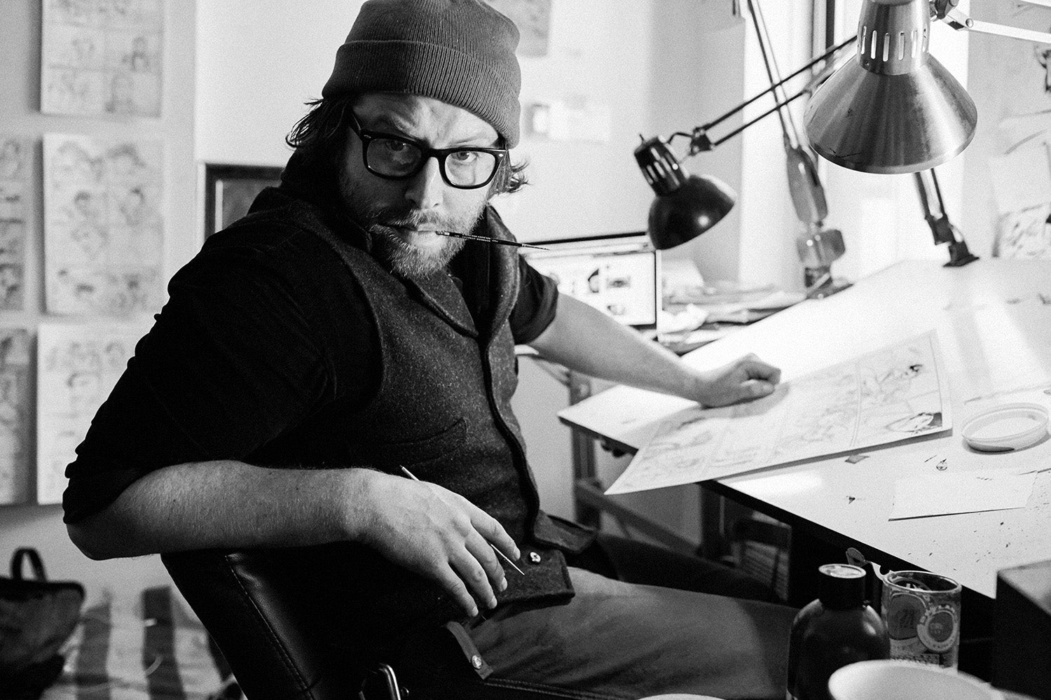 Chris Hunt seated at his drawing table